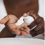 Woman putting LASPA Gentle Foaming Facial Cleanse on her hands. 