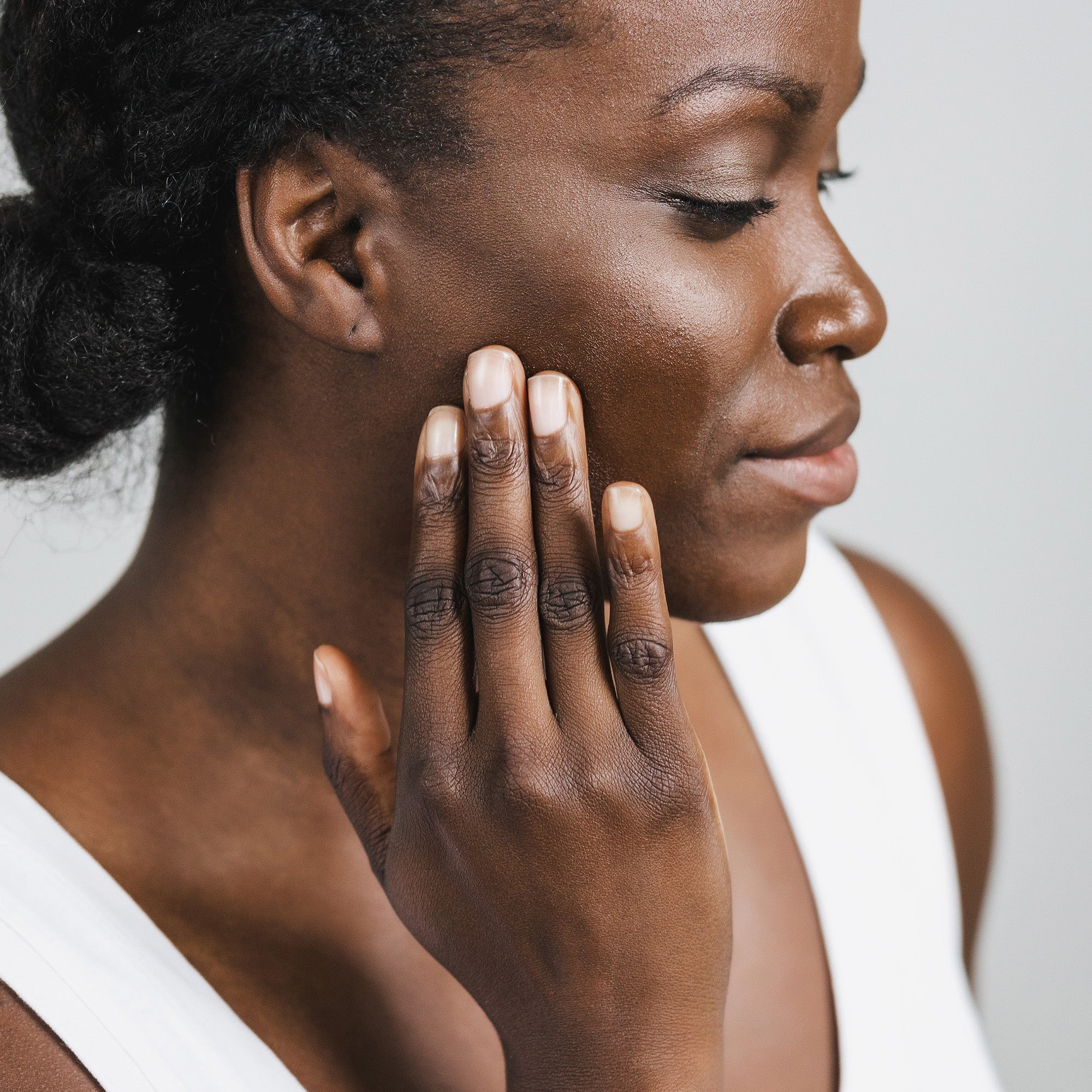 Woman applying sunscreen to her face. 