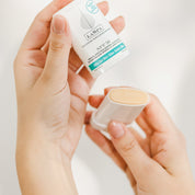 Hands holding LASPA SPF50 Ultra Sunscreen Stick